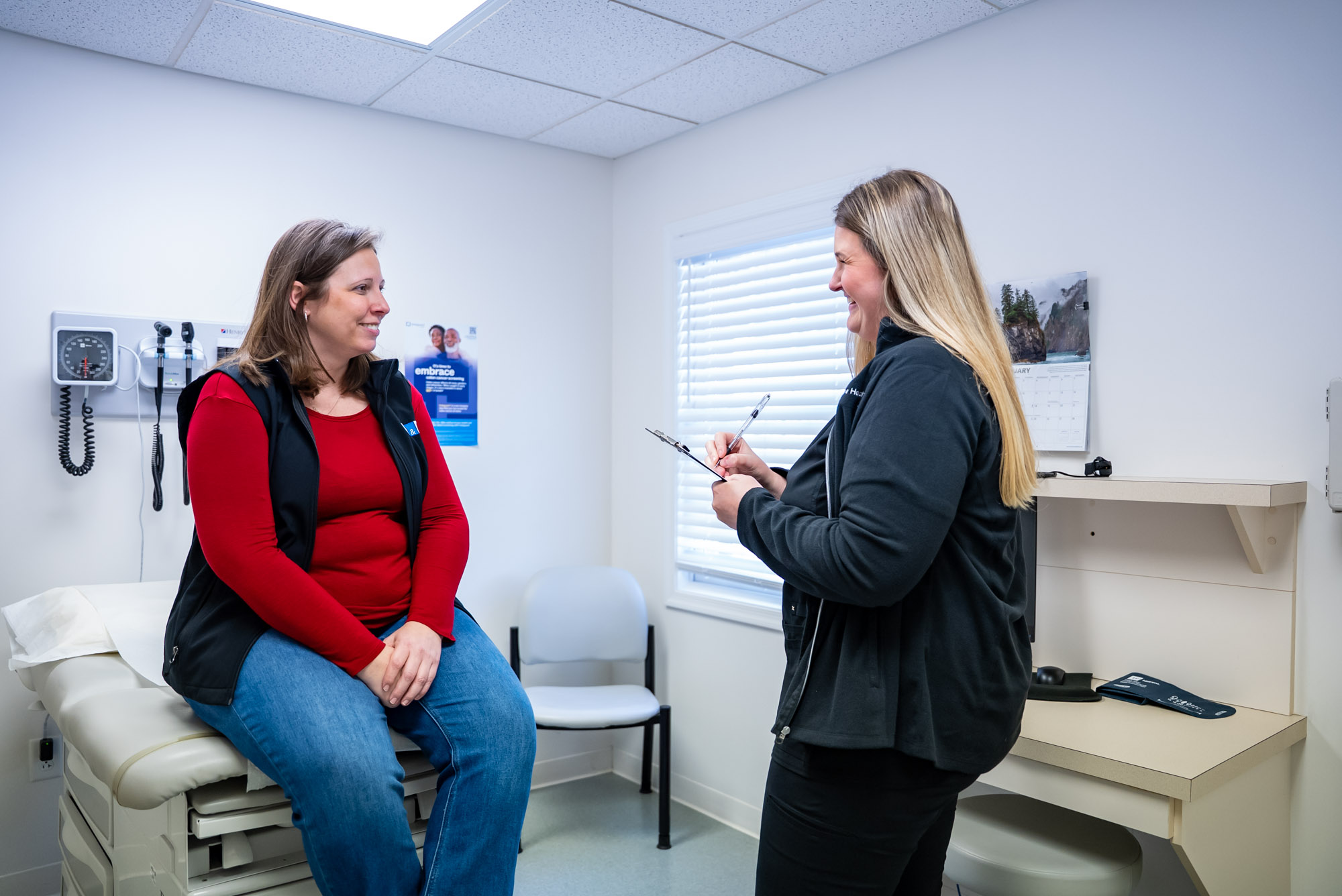 a woman answering questions in a doctors office